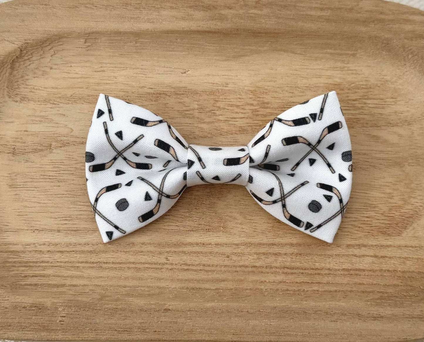 White bow tie with black Hockey Sticks and Hockey Pucks
